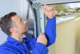 man repairing garage door