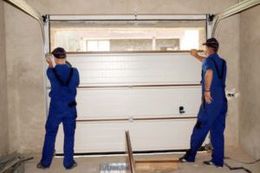 two men installing garage door