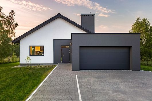 driveway leading up to garage on modern white and gray house