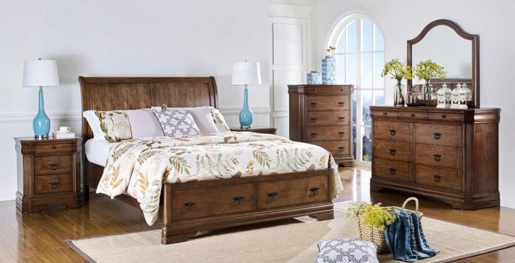 Classic bedroom suite with a bed, dresser, nightstand and mirror.