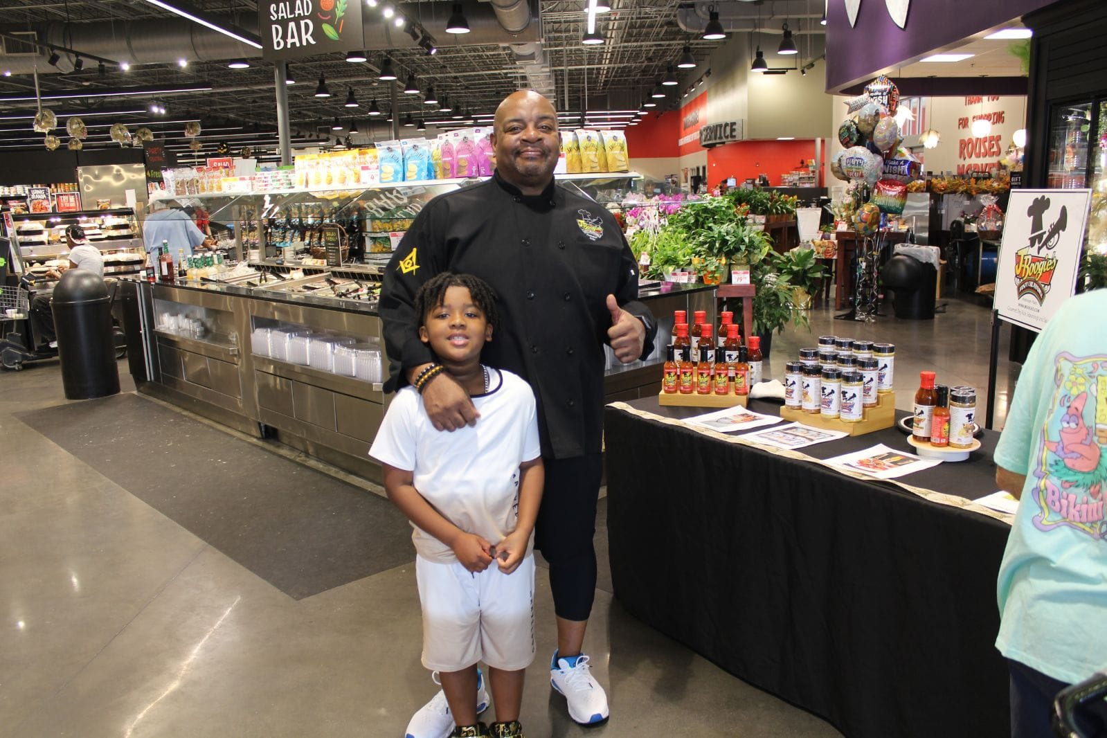 Darren, owner of J-Boogie’s Tasty Creations, pictured with a young fan during a customer appreciation event.