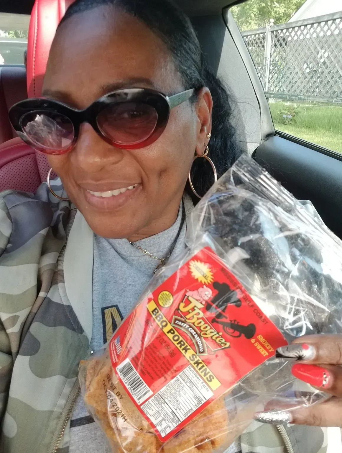 J-Boogie’s Tasty Creations customers showing appreciation and holding BBQ products during a special event.