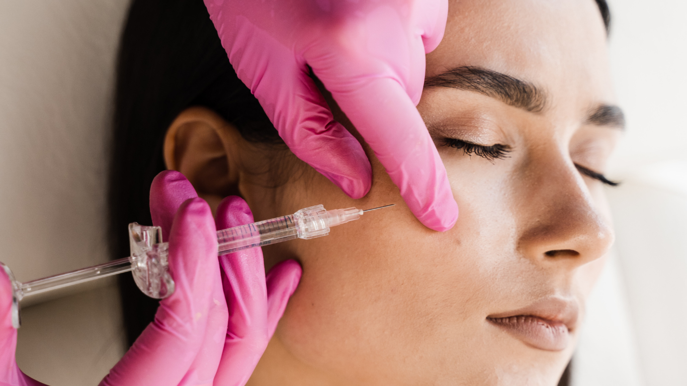 Patient laying down undergoing some form of laser hair treatment