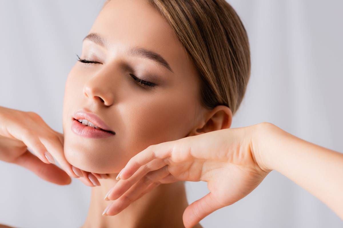 A woman touching her face after luxe laser treatment at Modern Dermatology of KY near Lexington, Kentucky (KY)