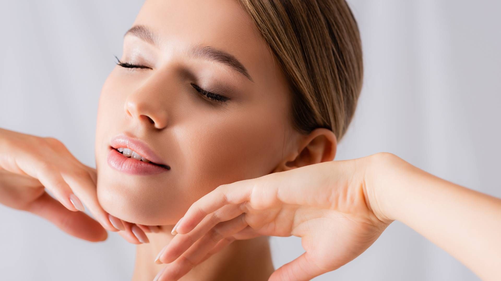 A woman touching her face after luxe laser treatment at Modern Dermatology of KY near Lexington, Ken