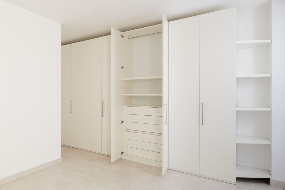 An Empty Room with White Cabinets and Shelves — All Trade Renovations- Peter Whelan in Terrigal, NSW