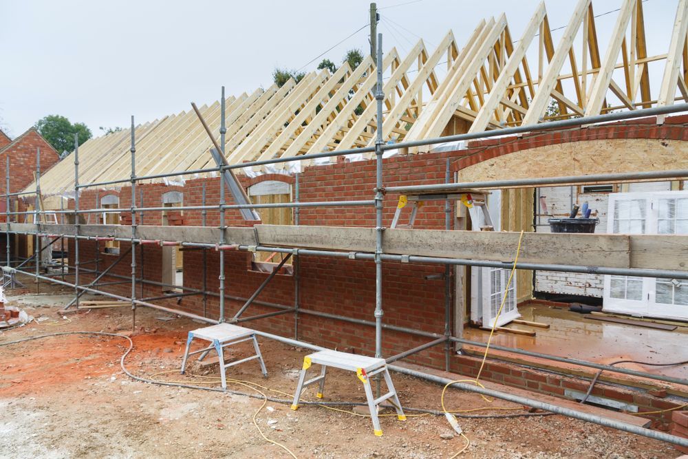 Brick Building With Scaffolding, Unfinished Roof Framing — All Trade Renovations- Peter Whelan in Wyoming, NSW