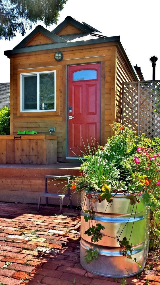 Small Wooden Cabin With Red Door, Window, and Flower Barrel — All Trade Renovations- Peter Whelan in Wyoming, NSW