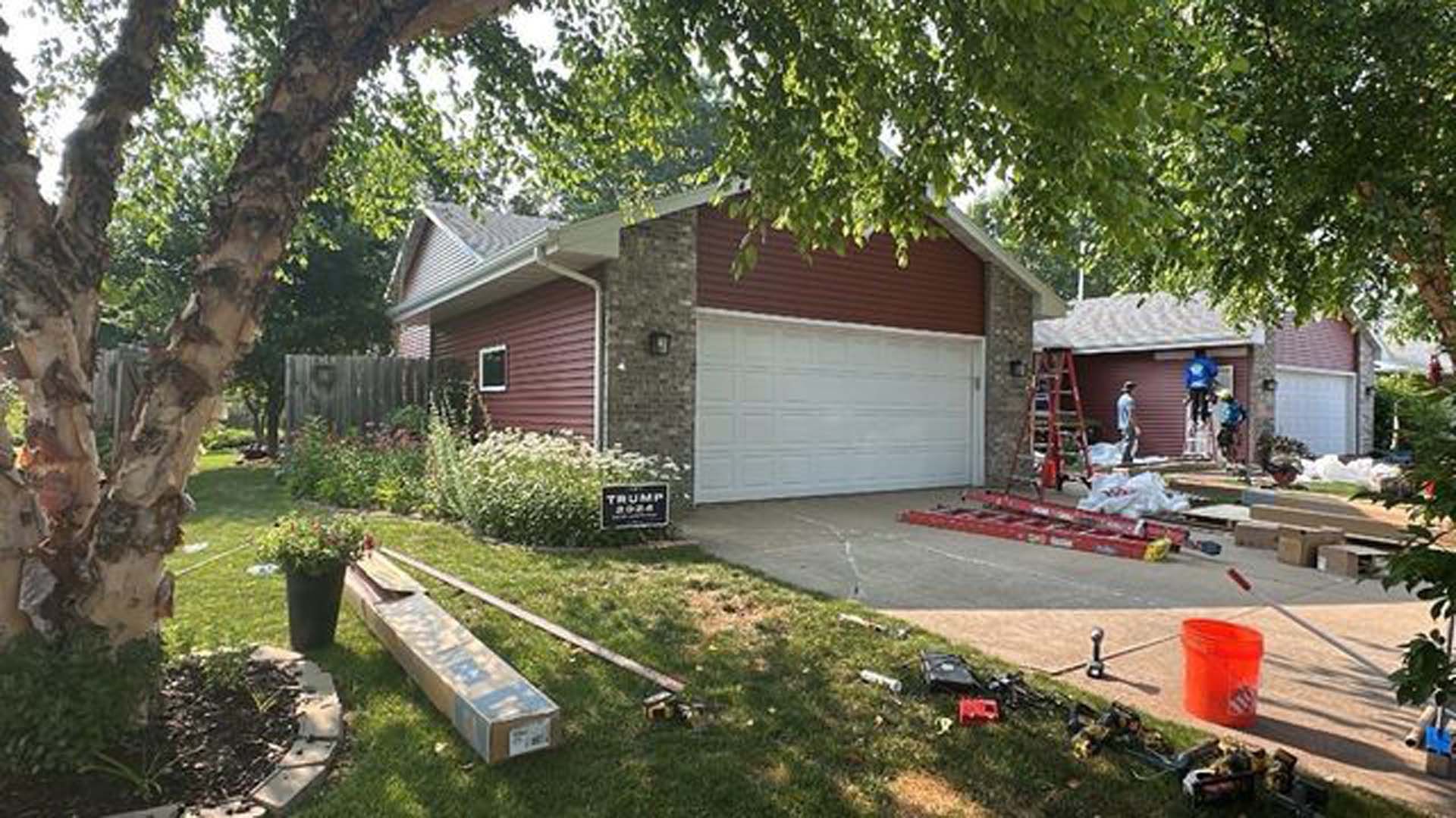 A house with a garage door is being remodeled.