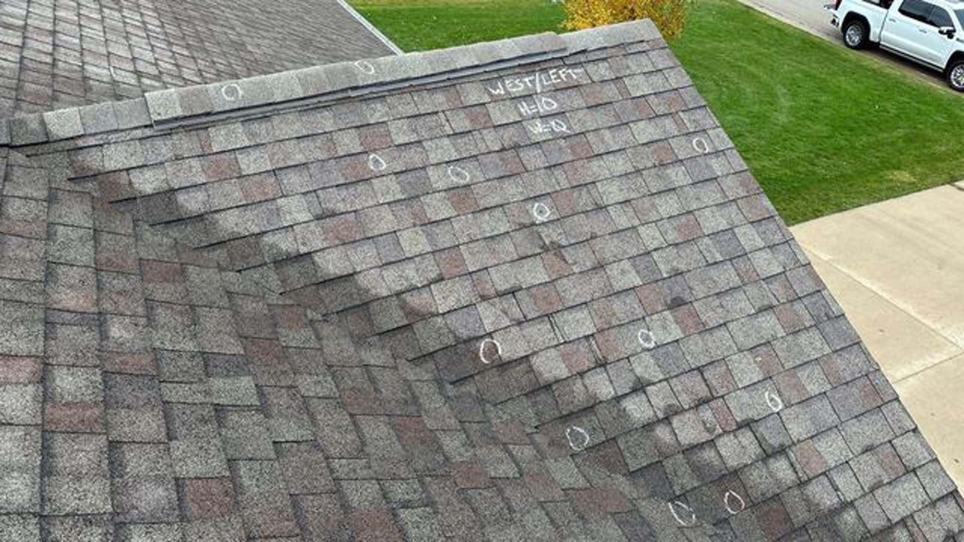 An aerial view of a roof with a truck parked in the driveway.