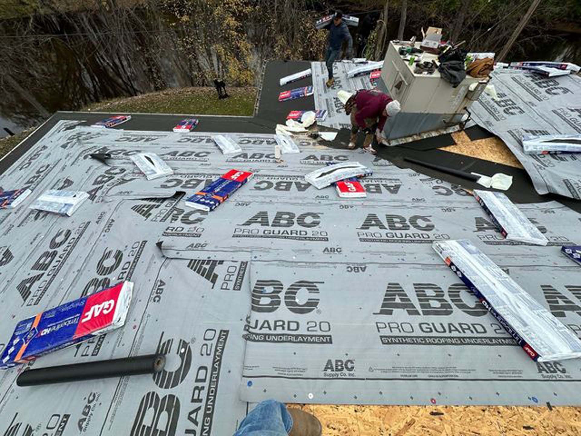 A man is working on the roof of a house.