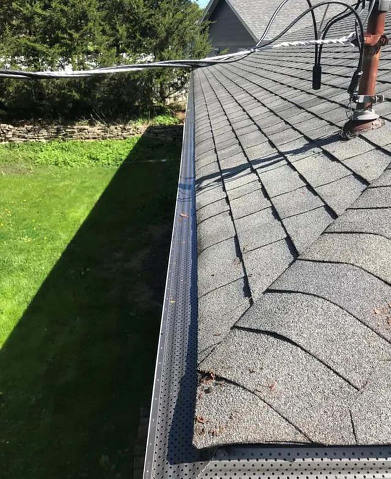 A person is working on the roof of a house.