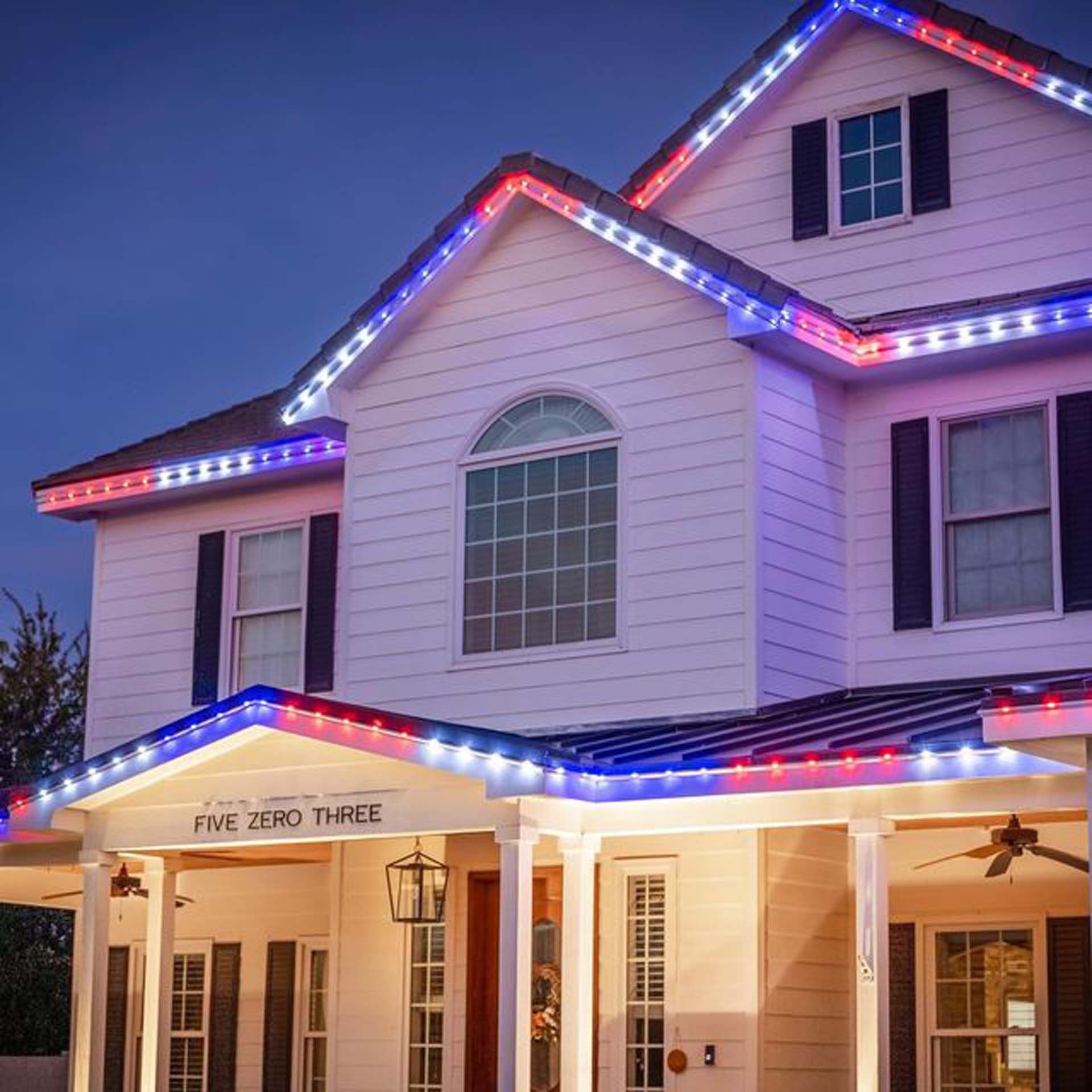 A white house with red white and blue lights on the roof