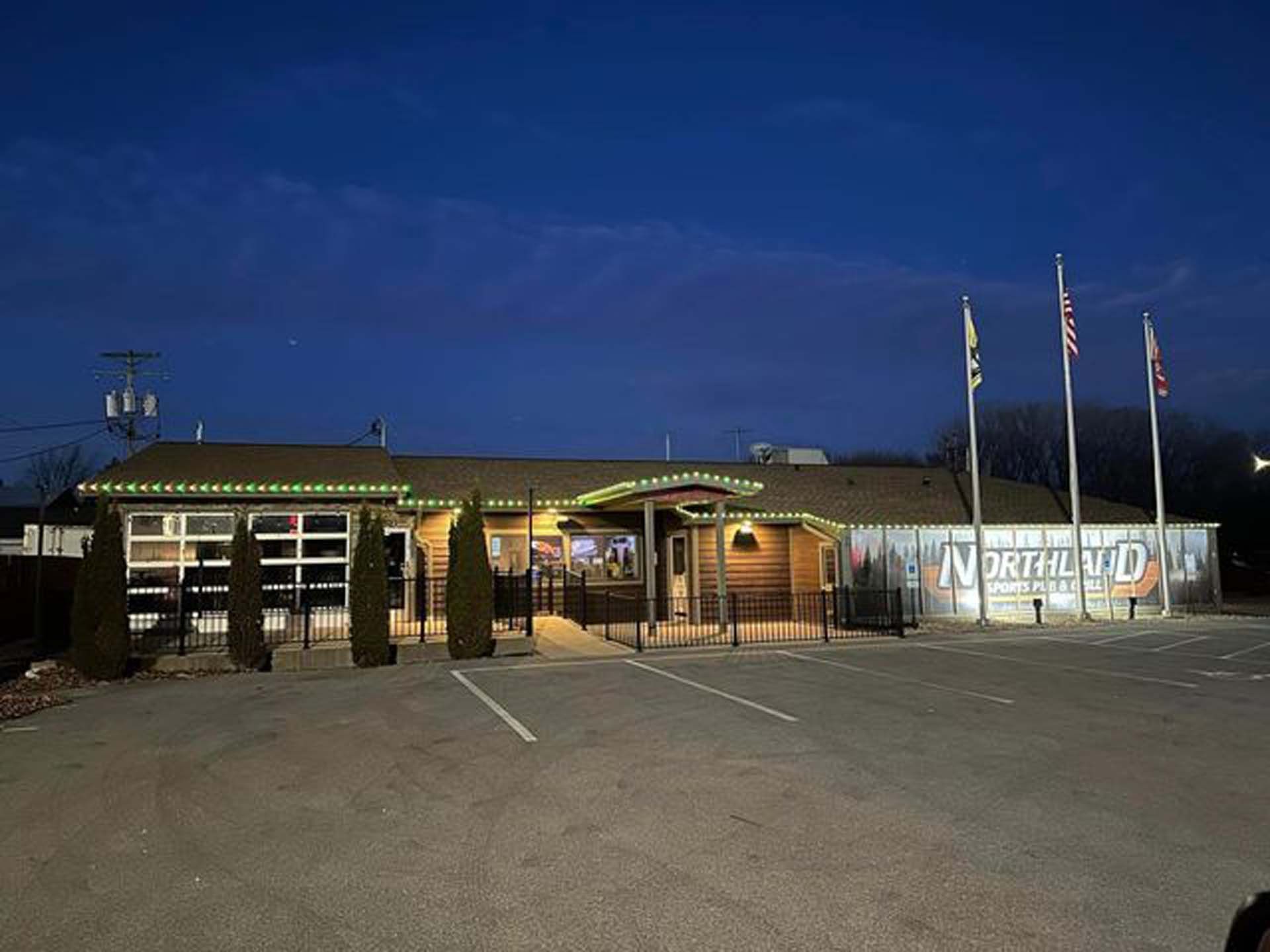 A large building with a lot of lights on it is lit up at night.