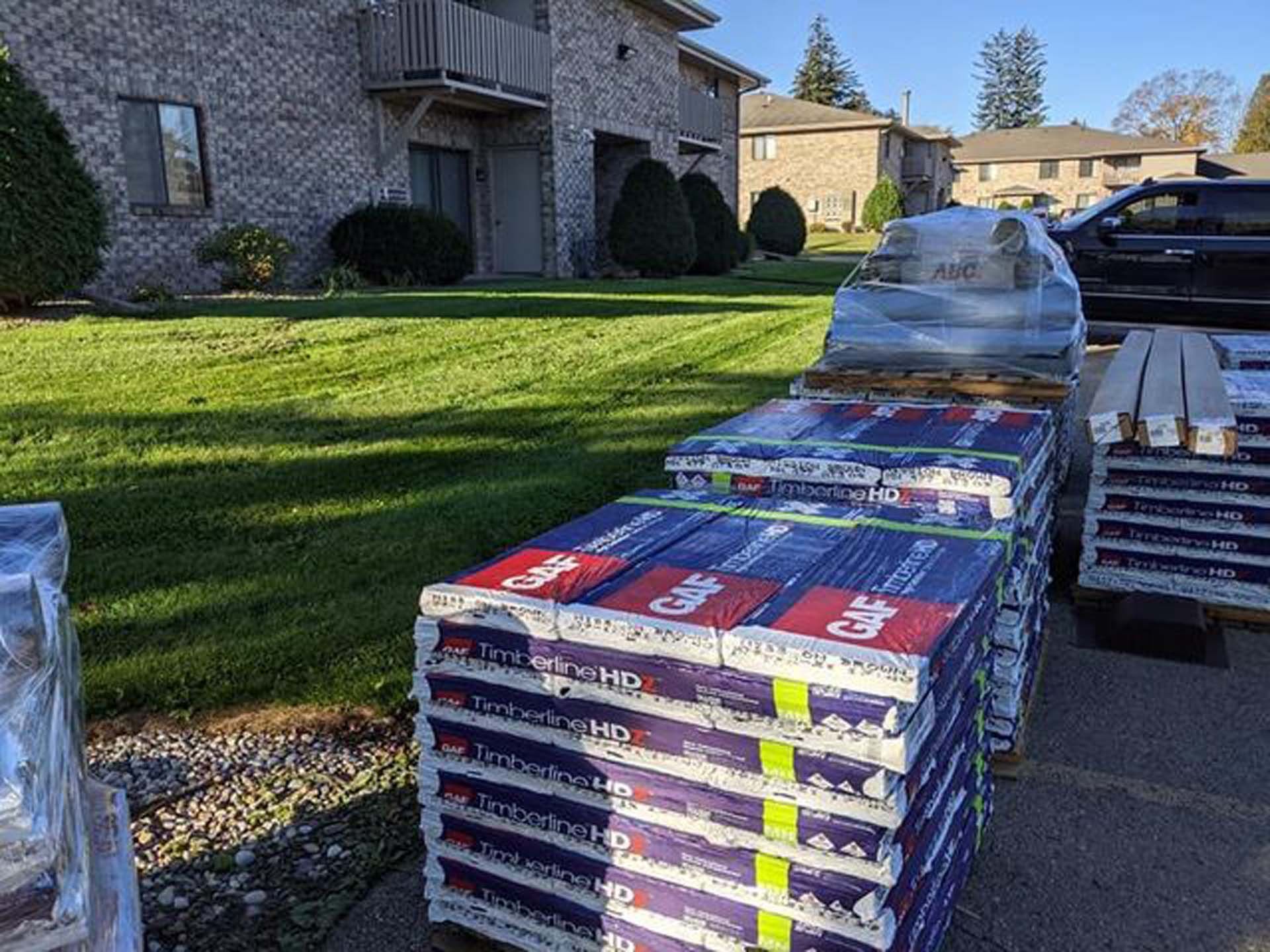 A bunch of boxes are stacked on top of each other in front of a building.