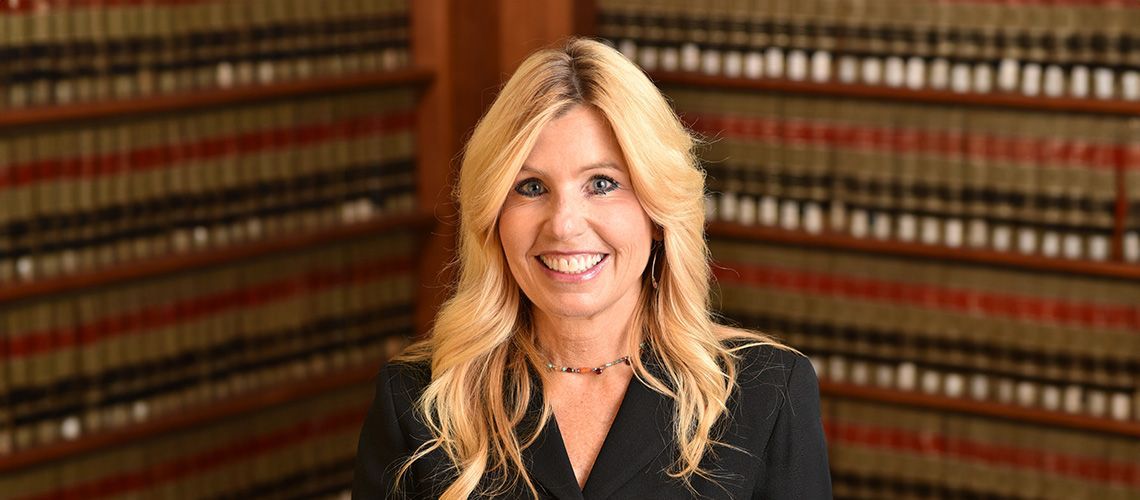 Diane Birnholz standing in a legal library