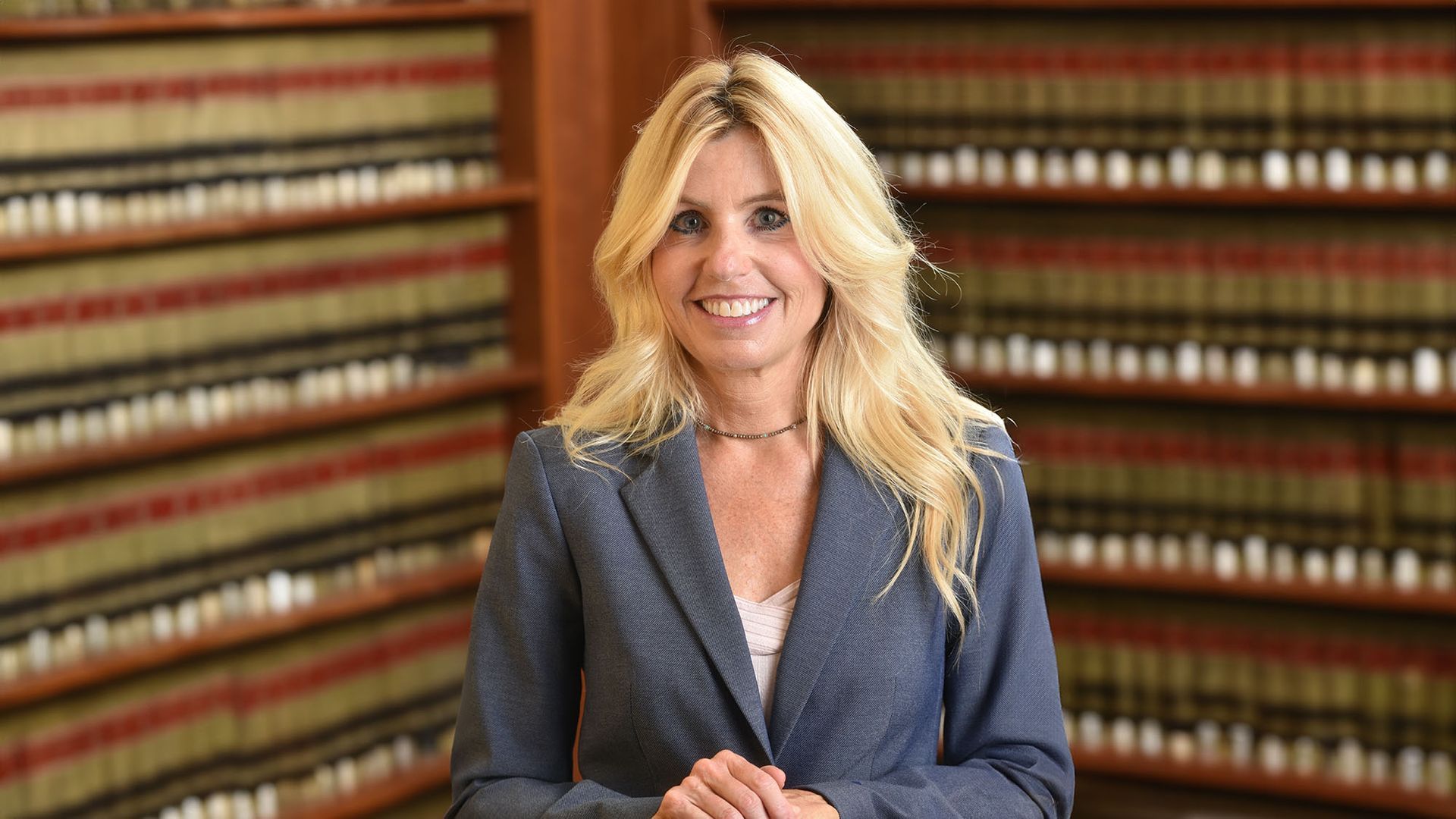 Diane Birnholz stands in front of a Legal Library in LA