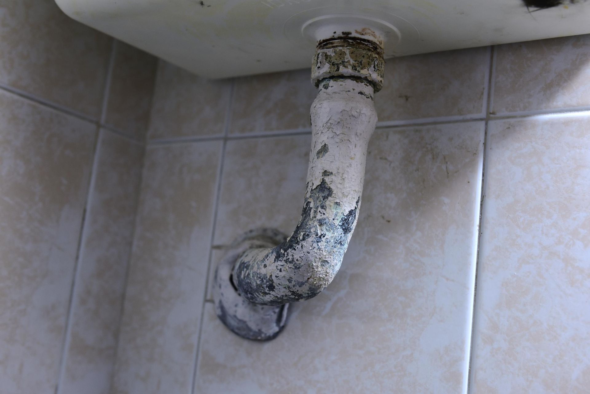 Lead pipe below a wash hand basin.