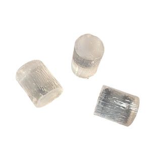 Three crystals are sitting on top of each other on a white surface.