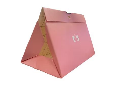 A pink box is sitting on top of a white surface.