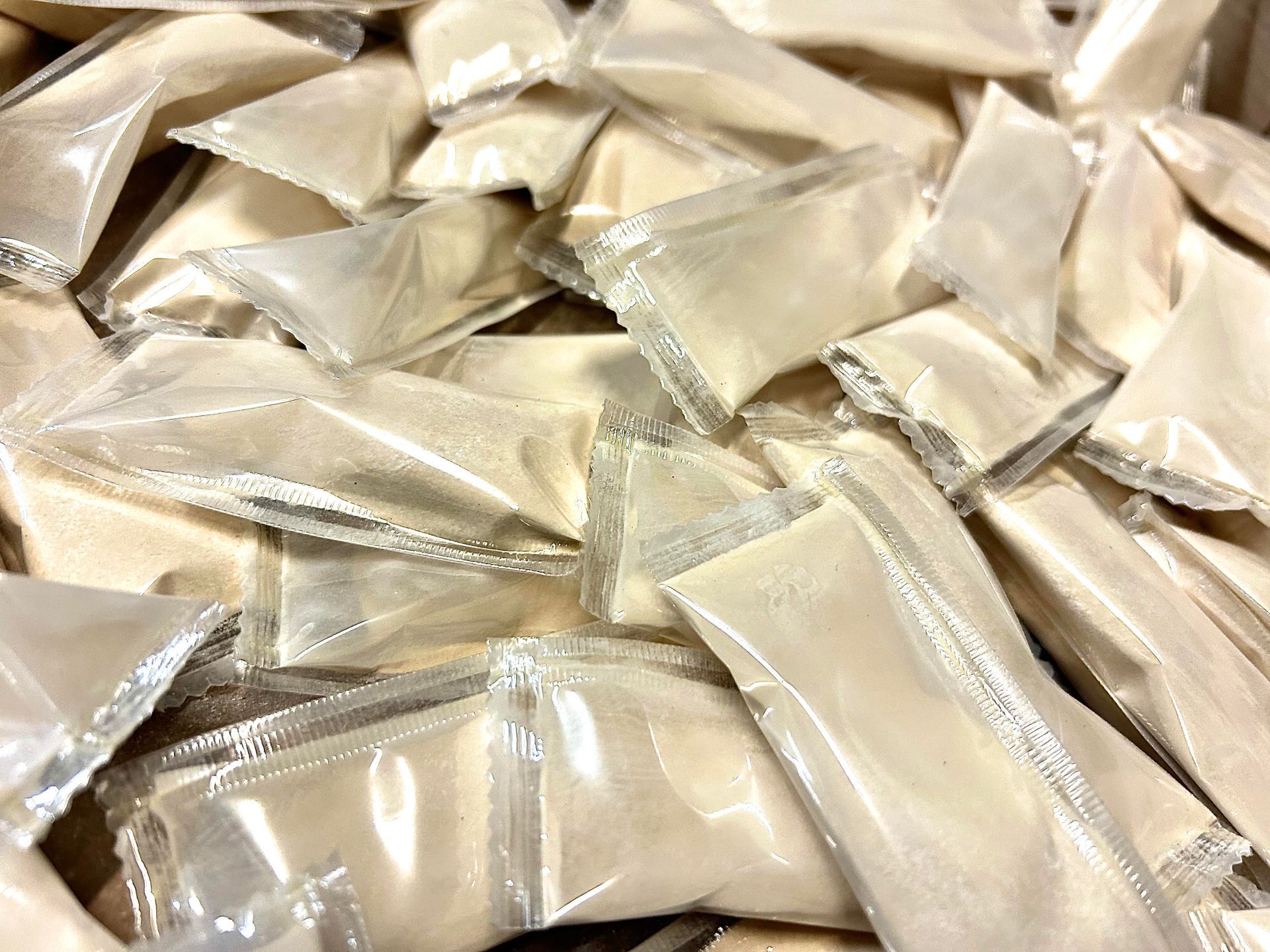 A pile of plastic bags filled with powdered sugar
