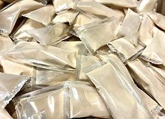 A pile of plastic bags filled with white powder.