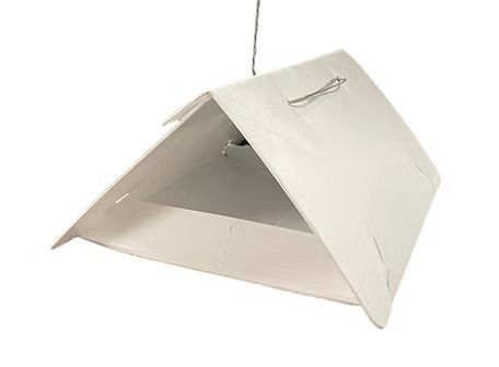 A white tent is hanging from a string on a white background.