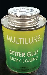 A can of multilure better glue sticky coating is sitting on a table.