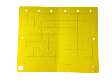 A yellow sheet of paper with holes in it on a white background.
