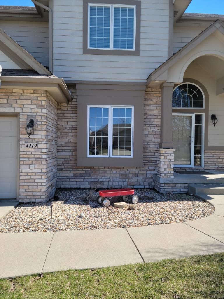 A red wagon is parked in front of a house