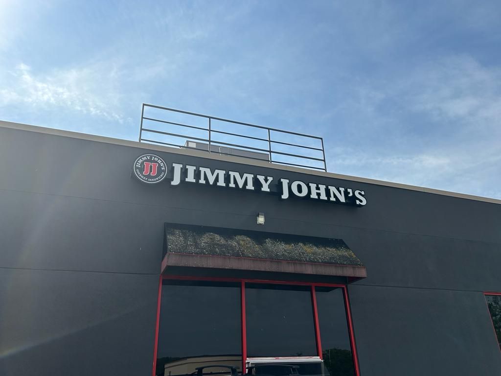 A jimmy john 's restaurant with a red awning