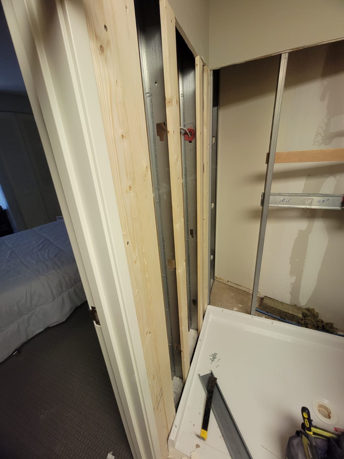 A door is being built in a room with wooden beams.