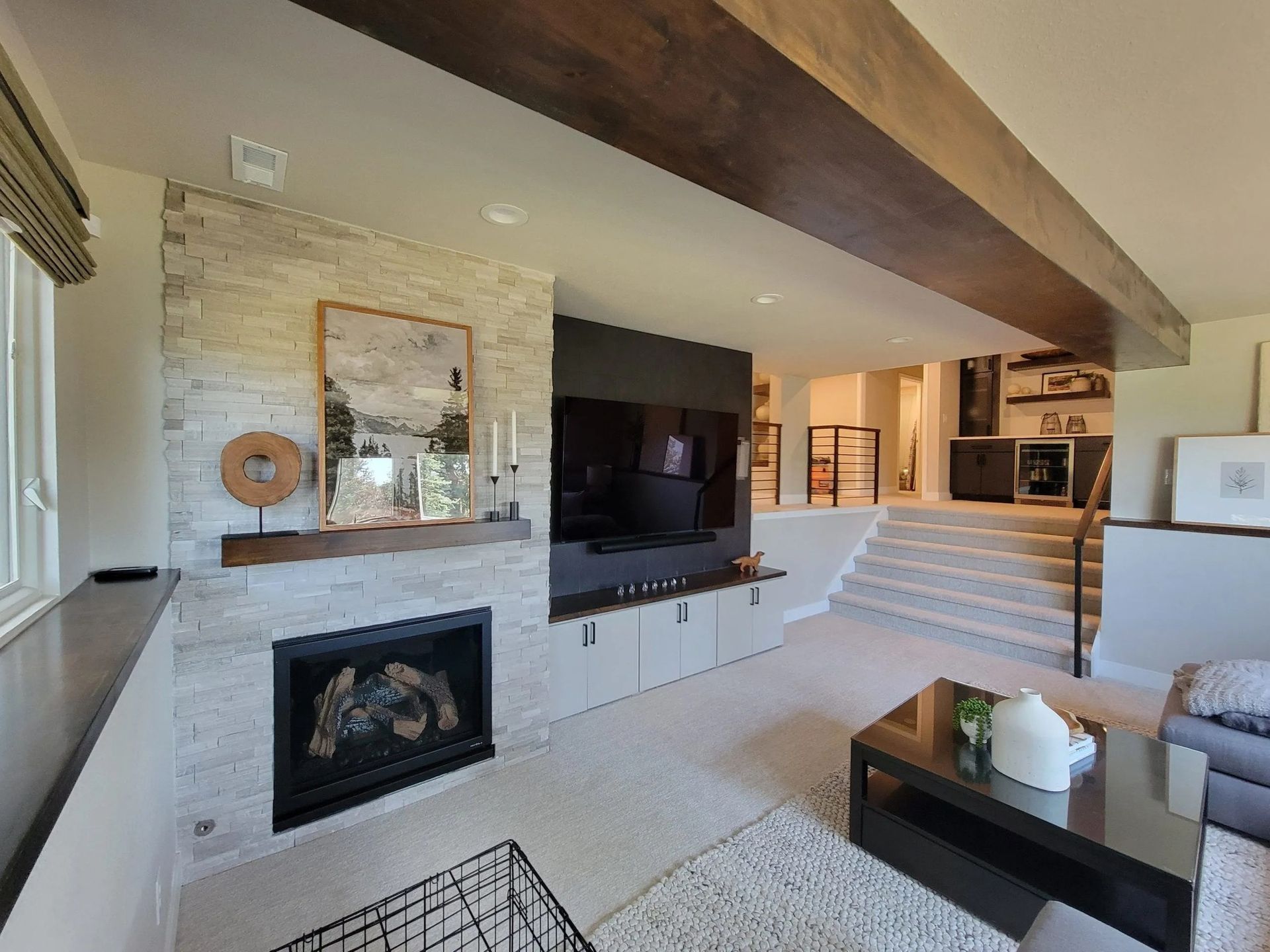 A living room with a fireplace and a flat screen tv