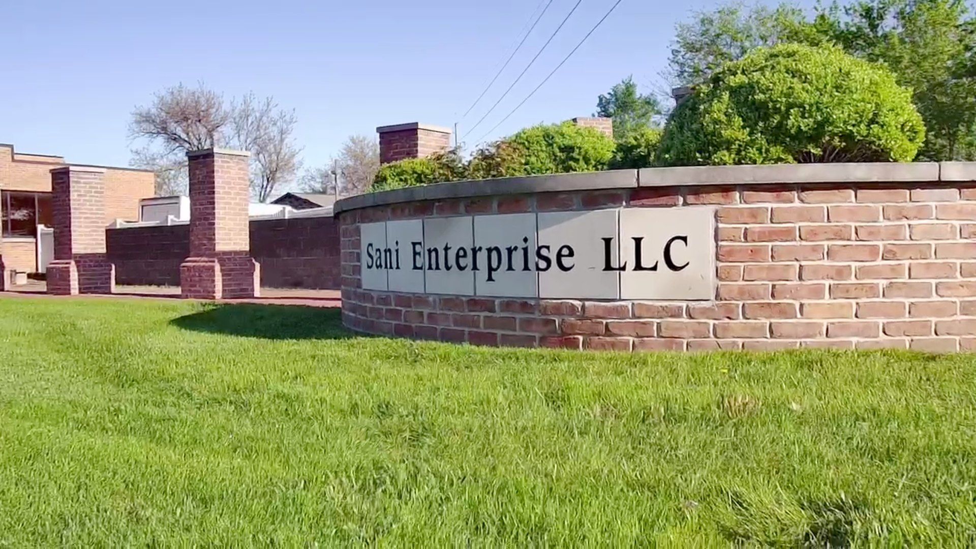 A sign on a brick wall says enterprise llc