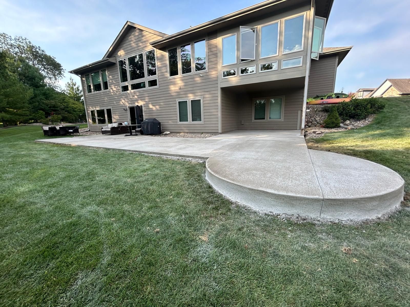A large house with a patio in front of it.