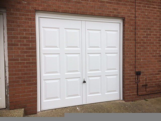 Wooden garage door painted white