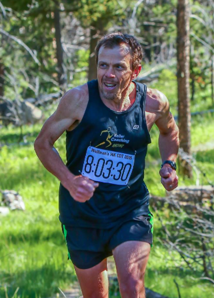 Photo of Kirk running in a race in the forest.