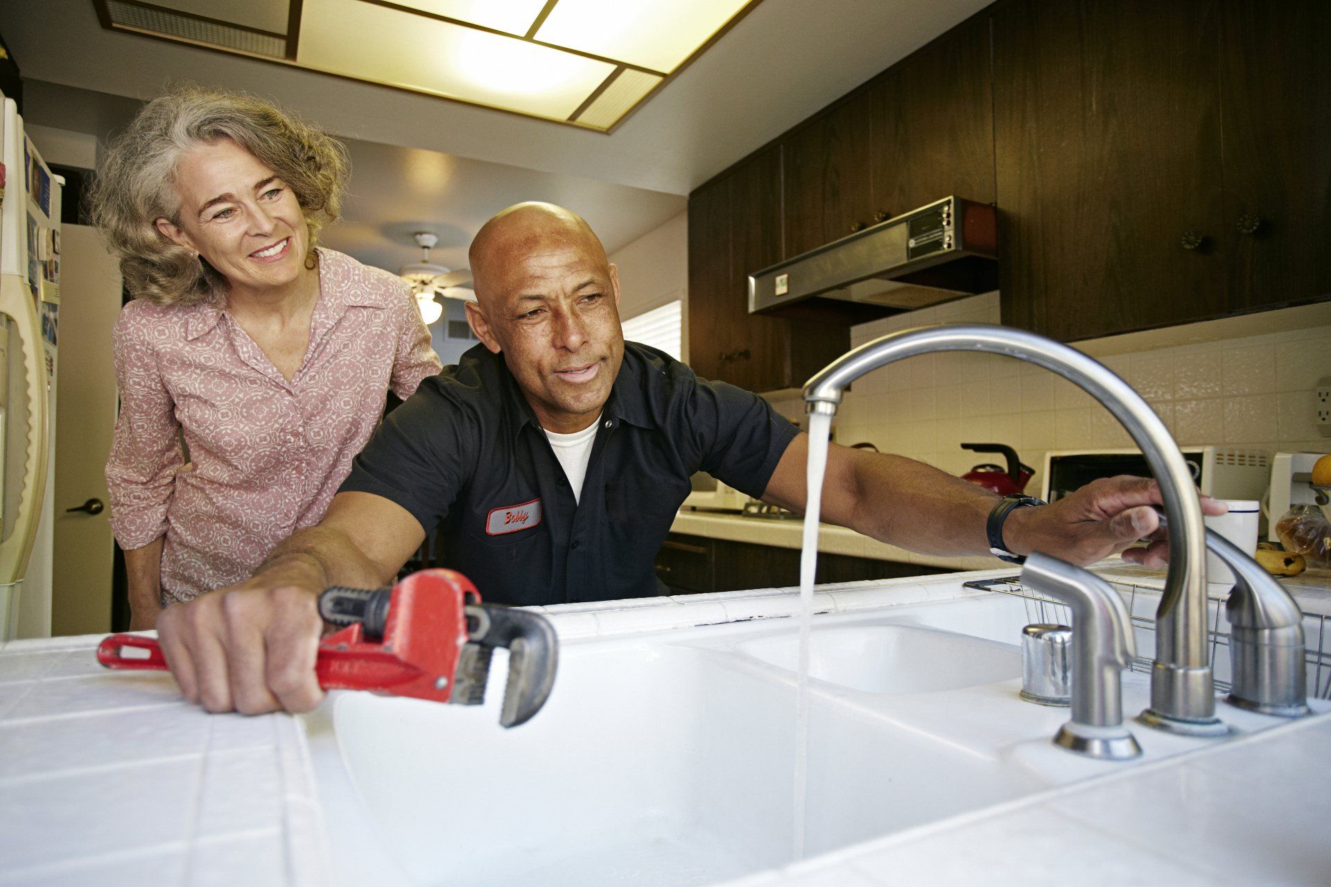 Man and Women Faucet Testing — Dunkirk, MD — C & C Mechanical Plumbing