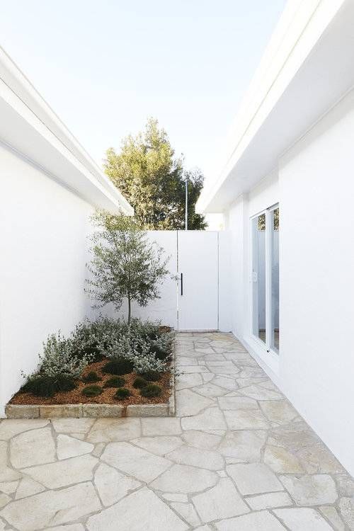 There Is A Patio With A Table And Chairs On It — Smart Tiles In South Kempsey, NSW