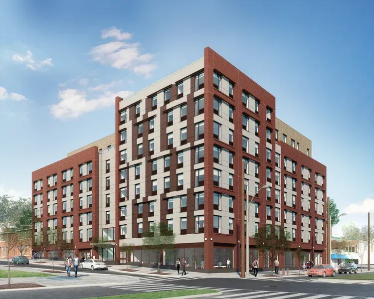 Building under construction; metal beams, concrete walls, and wooden frame. Clear blue sky.