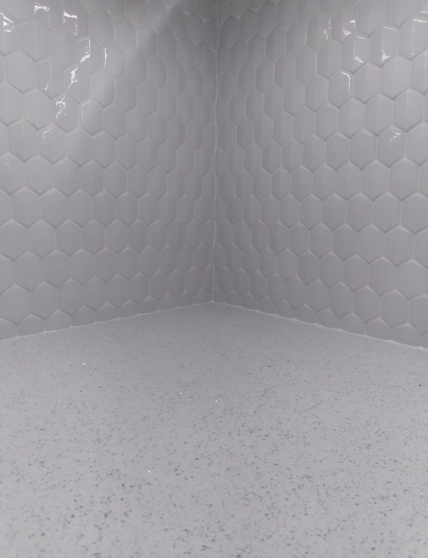 Tiled tub surround White tub with tiled shower and niche