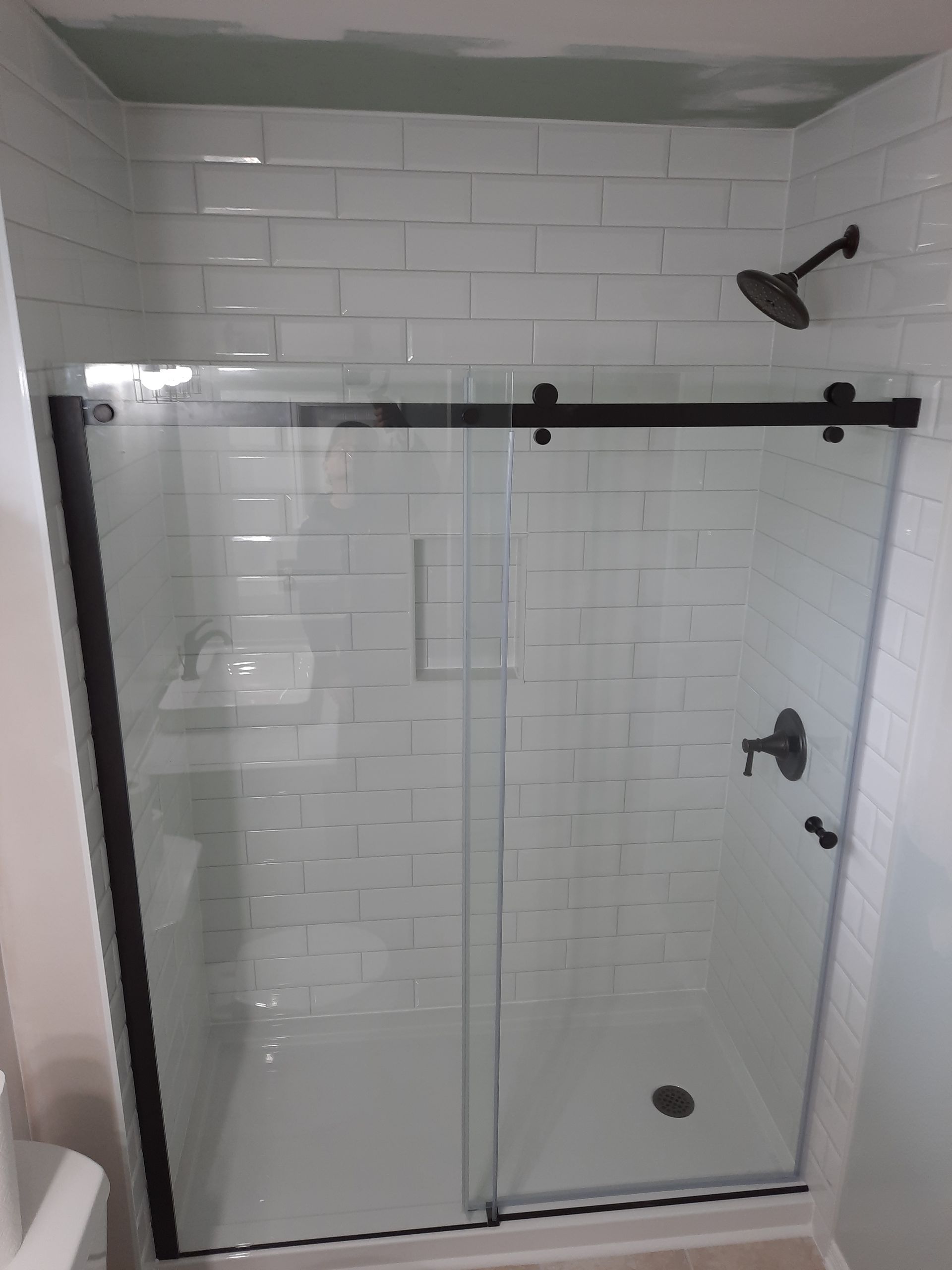 Tiled tub surround White tub with tiled shower and niche