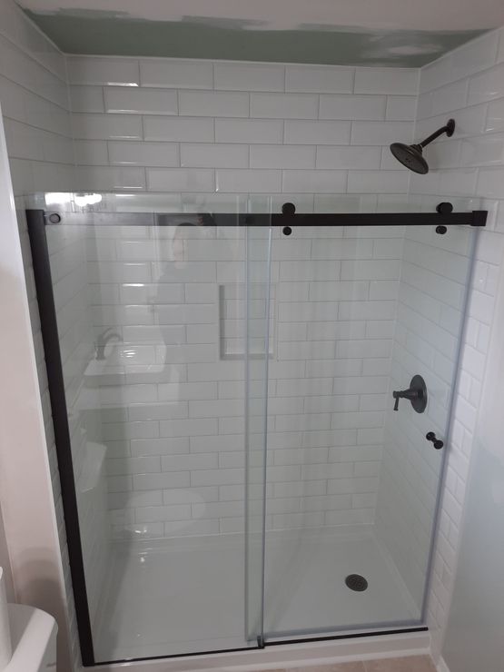 White tub with tiled shower and niche