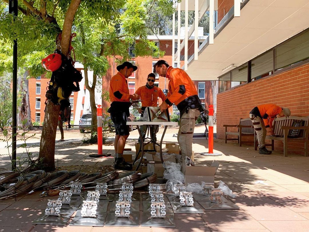 A group of men are standing around a table in front of a building.