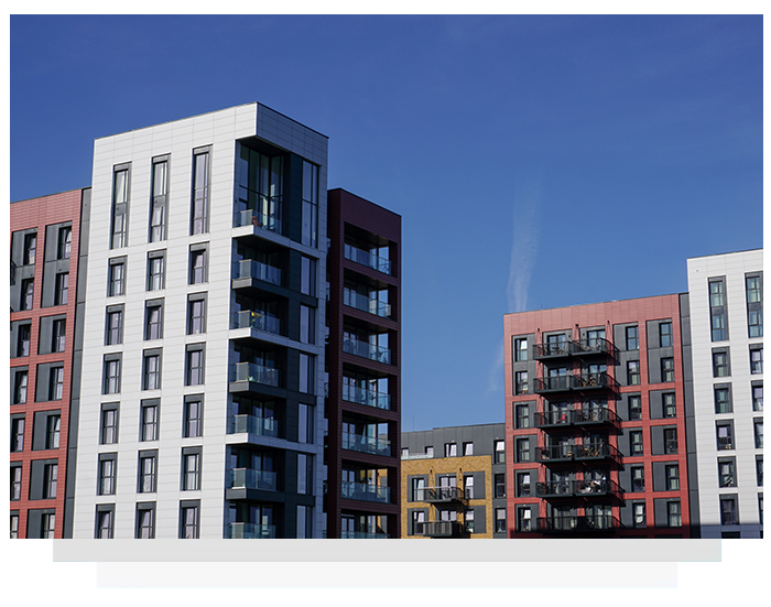 Modern apartment buildings with colorful facades against a blue sky.