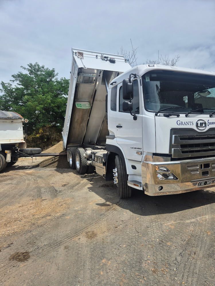 A White Truck Is Parked In The Middle Of A Dirt Field — Grants Excavations In Osbornes Flat, VIC