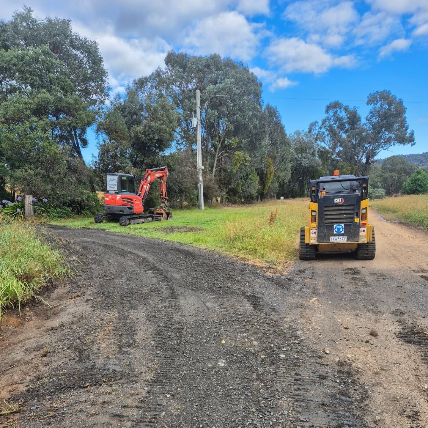 An Excavator Is Parked On The Side Of A Dirt Road — Grants Excavations In Osbornes Flat, VIC