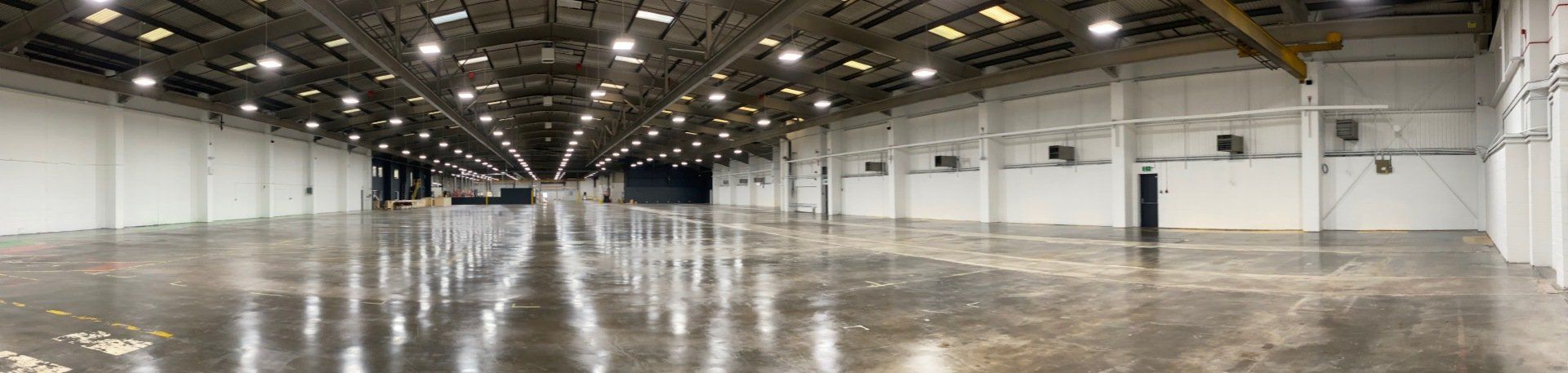 a large empty warehouse in need of warm air heating units