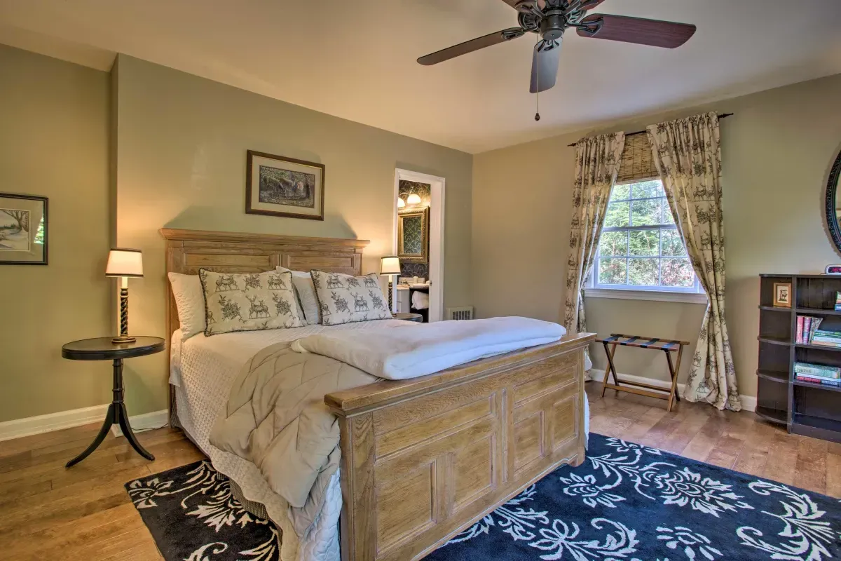 a bedroom with a large bed and a ceiling fan .