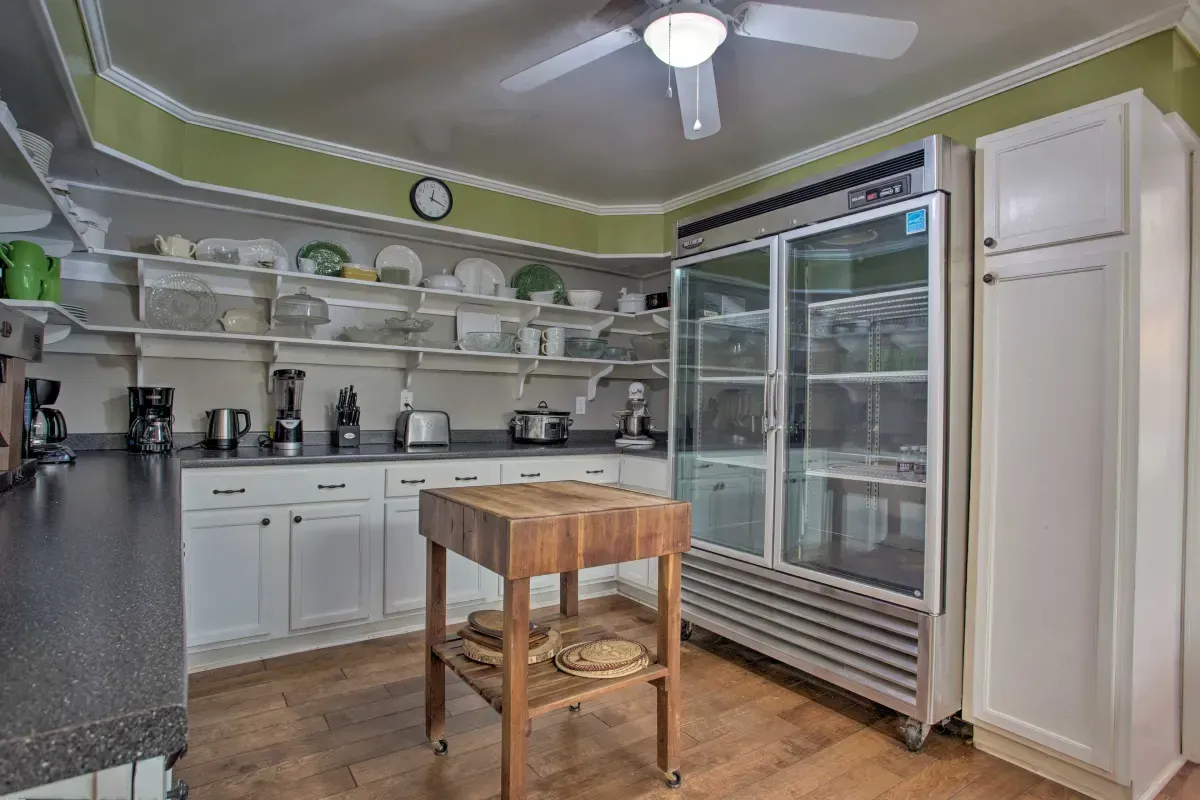 a kitchen with a cutting board and a refrigerator .